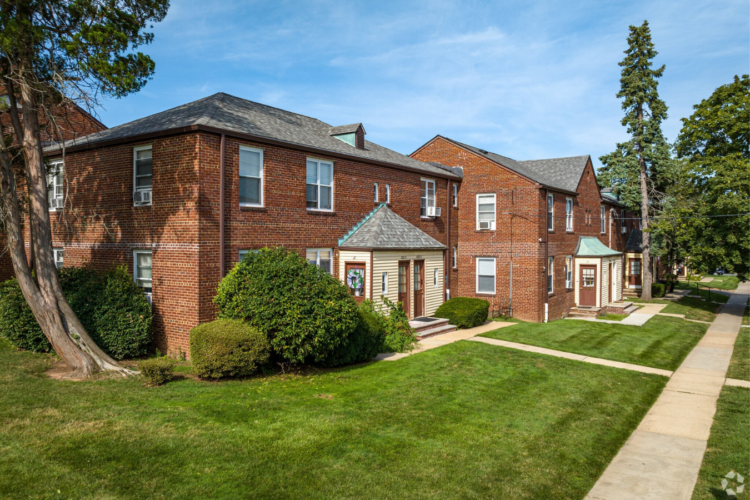 Classic brick apartment buildings on a tree-lined Linden street